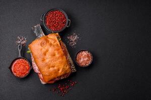 Focaccia with salami, cheese, tomatoes, arugula, salt, spices and herbs photo