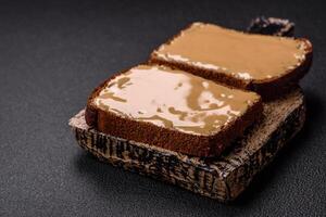 Sandwiches with toast bread, peanut butter and raspberry or strawberry jam photo