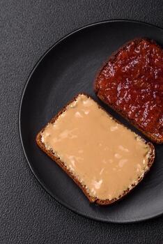 Sandwiches with toast bread, peanut butter and raspberry or strawberry jam photo