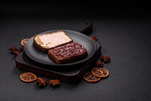 Sandwiches with toast bread, peanut butter and raspberry or strawberry jam photo