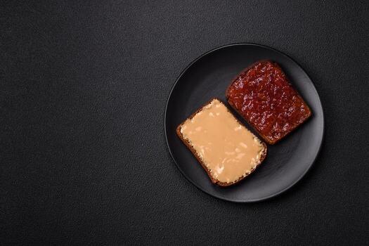 Sandwiches with toast bread, peanut butter and raspberry or strawberry jam photo