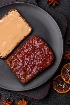 Sandwiches with toast bread, peanut butter and raspberry or strawberry jam photo