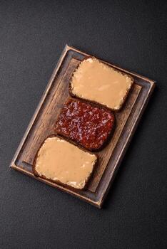 Sandwiches with toast bread, peanut butter and raspberry or strawberry jam photo