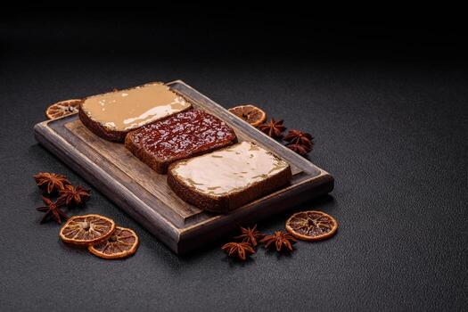 Sandwiches with toast bread, peanut butter and raspberry or strawberry jam photo