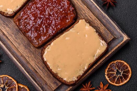 Sandwiches with toast bread, peanut butter and raspberry or strawberry jam photo