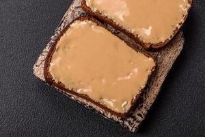 Sandwiches with toast bread, peanut butter and raspberry or strawberry jam photo
