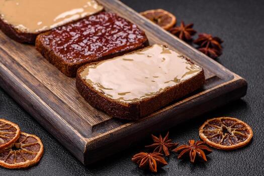 Sandwiches with toast bread, peanut butter and raspberry or strawberry jam photo