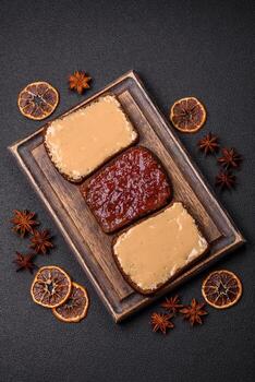 Sandwiches with toast bread, peanut butter and raspberry or strawberry jam photo