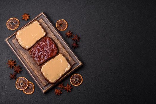 Sandwiches with toast bread, peanut butter and raspberry or strawberry jam photo