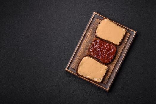 Sandwiches with toast bread, peanut butter and raspberry or strawberry jam photo