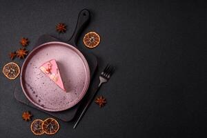 Piece of sweet cheesecake with pink cream cheese of raspberry or strawberry flavor photo