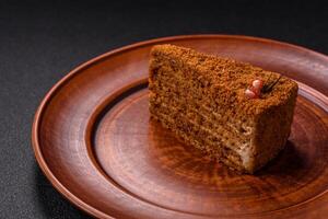 Piece of sweet layered honey cake photo
