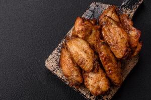 Grilled chicken wings with salt, spices and herbs photo