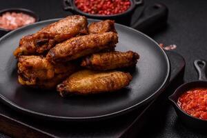 Grilled chicken wings with salt, spices and herbs photo