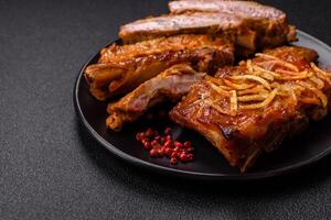 Pork or beef ribs with salt, spices and herbs baked on the grill photo