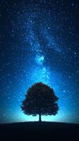 A solitary tree under a starry night sky. A solitary tree stands on a hillside, illuminated by a brilliant star-filled sky, creating a serene nighttime atmosphere. photo