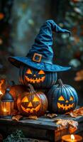 Halloween pumpkins with hat and lantern. Three carved pumpkins with glowing faces are stacked together, wearing a witch hat, surrounded by autumn leaves and a lantern. photo