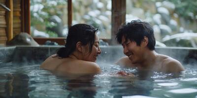 A couple cuddled up together in a hot spring but occasionally sneaking away to the nearby cold spring for a refreshing jolt photo