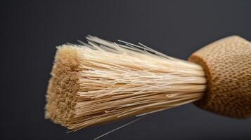 A macro shot of a bamboo pastry brush emphasizing the soft bristles and sy bamboo handle. The natural fibers of the bristles are clearly visible photo