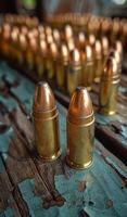 Two bullets are on a wooden table. The table is covered in gun bullets. Scene is tense and serious. photo