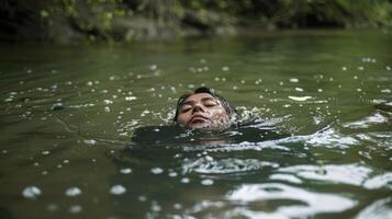 A peaceful river with a person floating on their back eyes closed and fully embraced by the chilly water photo