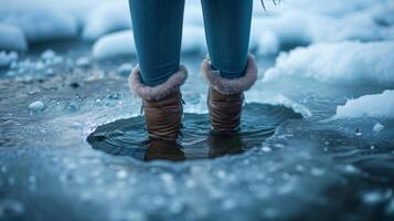 A woman dips her toes into a small hole into the icedover surface of a lake her expression a mix of trepidation and excitement photo