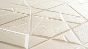 A closeup of a set of embossed note cards featuring a geometric pattern that is both modern and elegant. The raised lines and shapes give the stationery a unique texture that adds interes photo