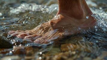 One foot cautiously stepping in and then quickly adjusting to the temperature of the cold water photo