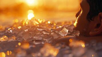 The vibrant colors of a sunset mirrored in the ice chips floating in a persons bath as they soak their tired muscles photo