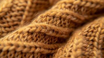 The texture of a handknitted sweater captured up close showcasing the mix of smooth and bumpy stitches in a warm earthy color photo