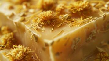 A bar of calendula soap boasts a golden hue and tiny flecks of calendula petals promising to soothe and heal dry or sensitive skin photo
