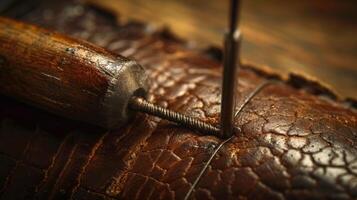 A leatherworkers stitching awl the sy handle bearing marks from countless punctures photo