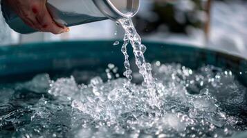 10. A person pouring buckets of ice into a pool preparing for a mentally challenging cold plunge photo