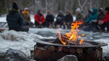 A group of people gathering around a fire pit sharing stories after a day of cold water immersion photo