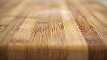 A closeup of a bamboo ting board highlighting the smooth and even surface of the wood. The intricate patterns of the grain add visual interest to the board photo
