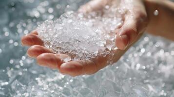 Closeup of a persons hand gently breaking the surface of the ice bath a symbol of the gentle and mindful approach that is often present in holistic healing practices photo