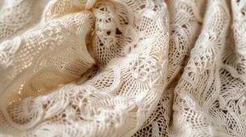 The closeup of a handknitted shawl showcasing the intricate lacelike stitches and the delicate d of the fabric photo