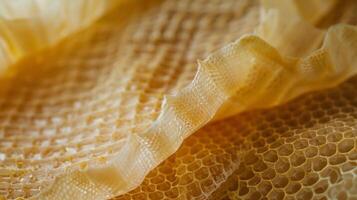 A macro shot of a beeswax food wrap shows the intricate layering process of beeswax and fabric creating a durable and sustainable alternative to plastic wraps photo