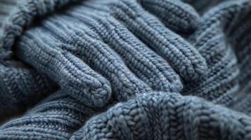 A zoomedin shot of a pair of fingerless gloves highlighting the ribbed cuffs and the tight precise stitching between each finger photo