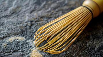 A detailed shot of a bamboo whisk capturing the fine lines and knots in the material. The exposed ends of the whisk show the raw natural appearance of the bamboo photo