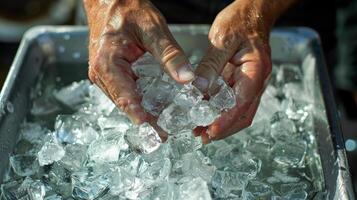 Hands stirring the ice bath trying to evenly distribute the ice cubes photo