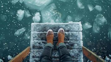A woman sits on a dock her feet dangling in the icy waters below journaling and reflecting on her personal journey of selfdiscovery and wellness photo