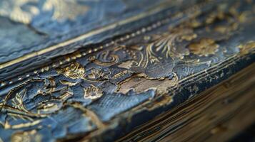 A closeup of the spine reveals intricate embossed designs and fading gold lettering. There are also small tears and frayed edges adding to the books wellloved appearance photo