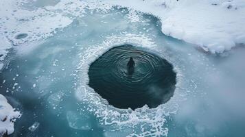 A frozen lake with a hole out showing a person submerged in the icy water for healing photo