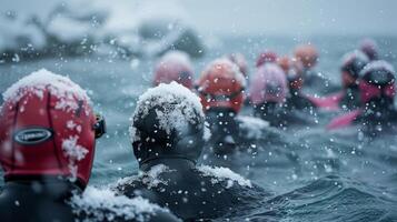 Snowflakes gently fall onto the heads of shivering swimmers as they wait for their turn to take on the challenging open water course photo