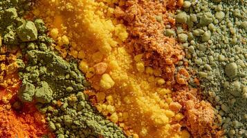In this image vibrant shades of green and yellow stand out against a background of deep red and orange es. The finely ground herbs appear almost fluffy while the co seeds add a grain photo