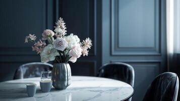 A minimalist dining room with muted navy walls a sleek marble dining table and velvet charcoal chairs accented with a muted blush bouquet centerpiece photo