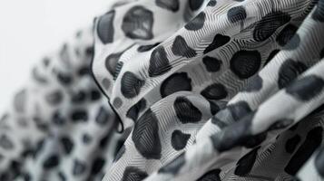 A monochrome print midi dress featuring leopard spots in shades of grey. The flowy silhouette and high neckline make it a stylish and refined choice for any occasion photo