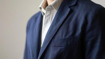 A staple navy blue blazer made from a durable and soft cotton blend ideal for transitioning from work to dinner with ease photo