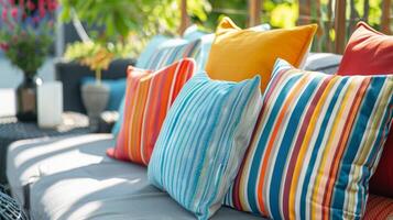 A cozy and inviting outdoor nook featuring a mix of bold and cheerful striped cushions ideal for soaking up some sun or enjoying a cold drink on a warm summer day photo